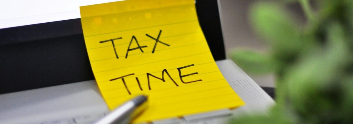 Yellow sticky note reminder to do New Hampshire property taxes.